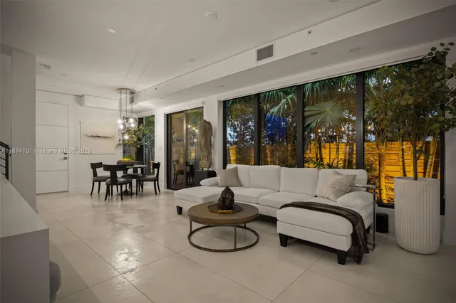 a living room with furniture and large windows