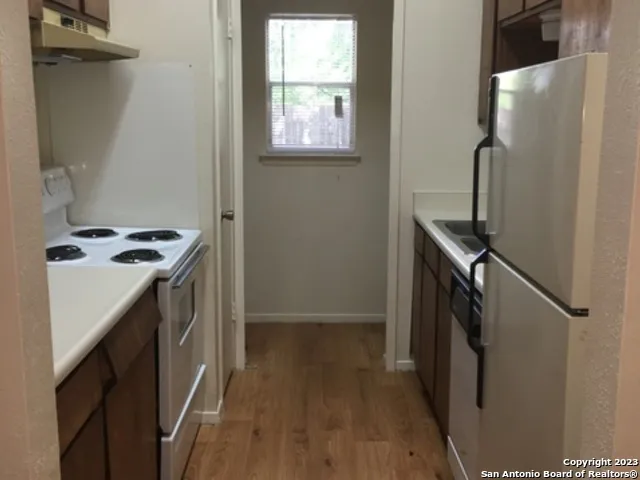 a utility room with cabinets washer and dryer