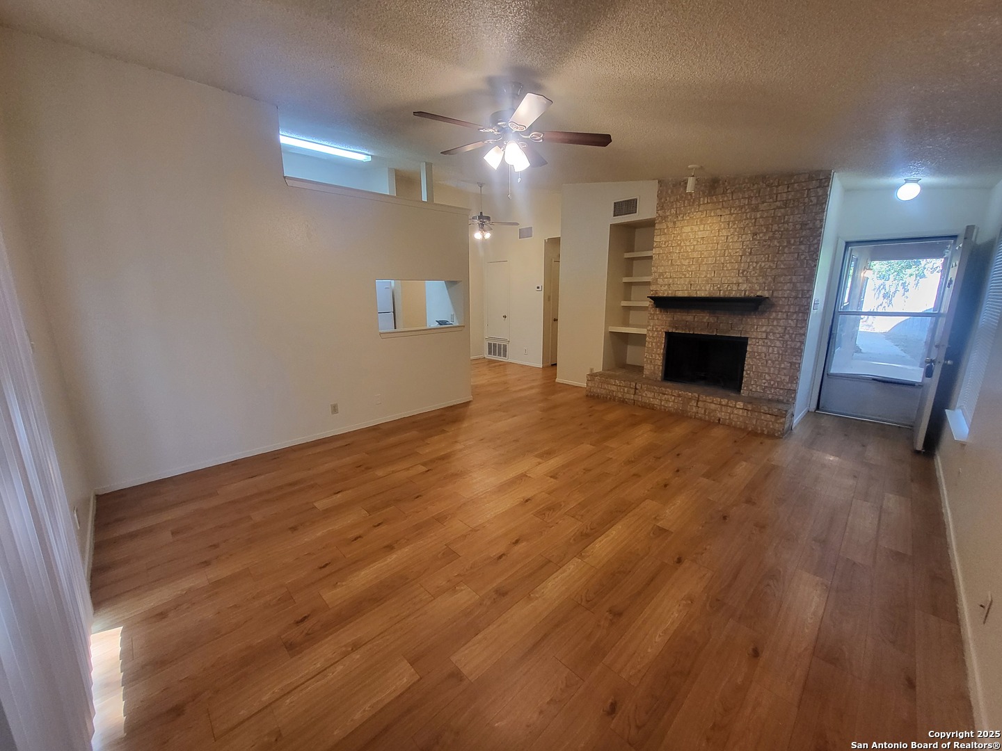 14524 Waddesdon Bluff San Antonio, TX 78233 - Photo 5 of 10 a view of an empty room with a fireplace and a window