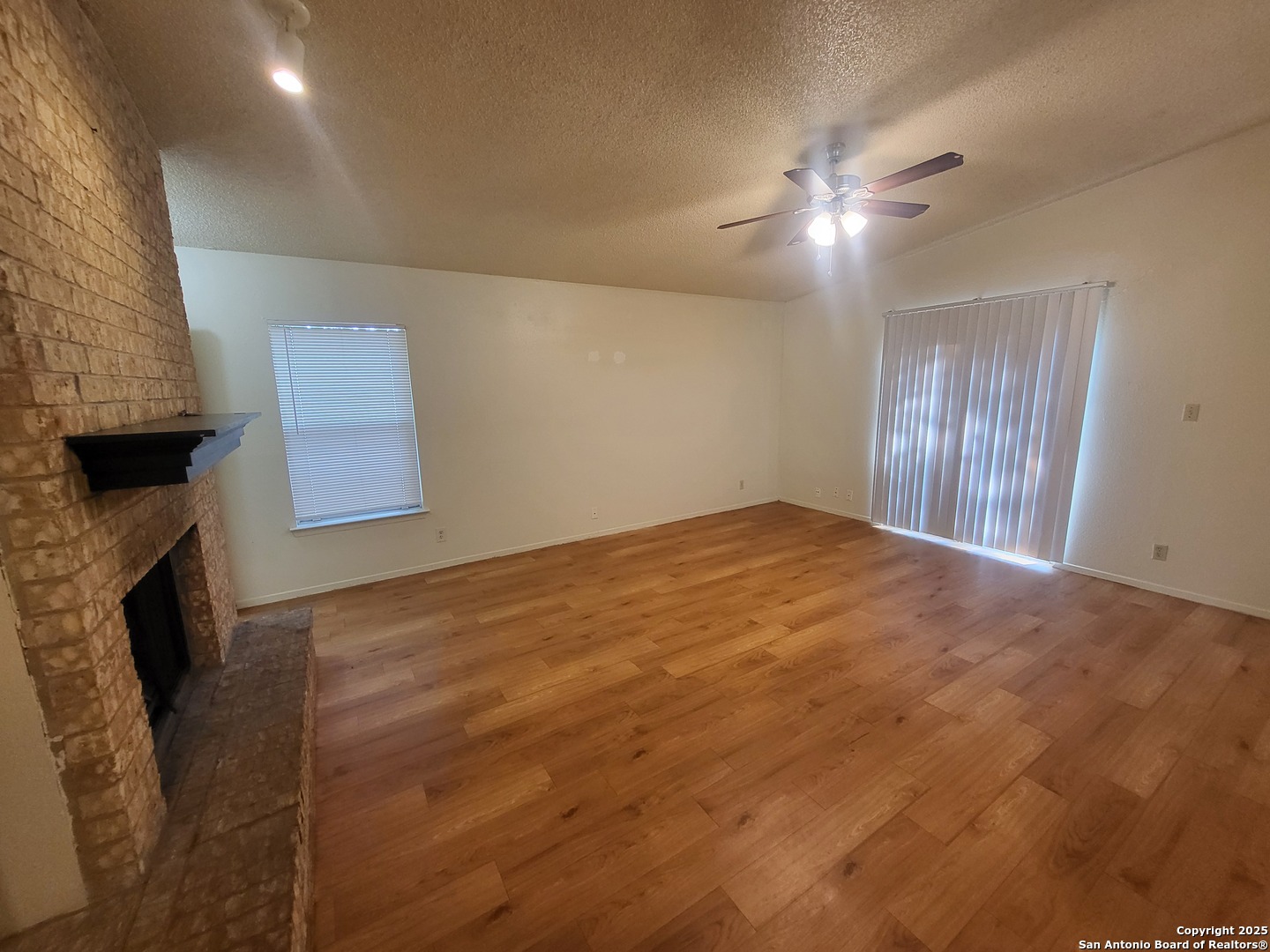14524 Waddesdon Bluff San Antonio, TX 78233 - Photo 6 of 10 a view of an empty room with a ceiling fan and window