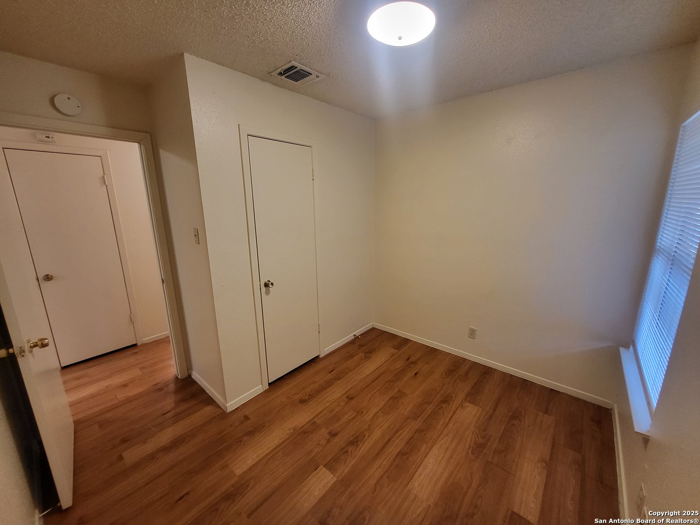 14524 Waddesdon Bluff San Antonio, TX 78233 - Photo 8 of 10 a view of empty room with wooden floor