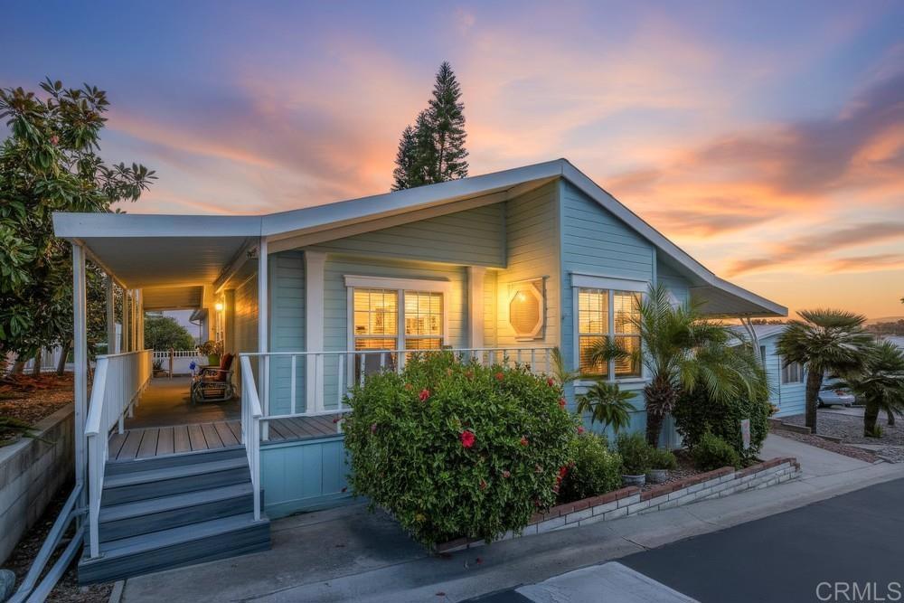 a view of a house with potted plants