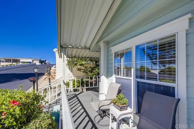 a view of a porch with chairs and potted plants