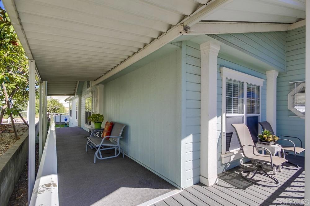 9500 Harritt Road, Unit 106 Lakeside, CA 92040 - Photo 17 of 35 a view of a patio with table and chairs and wooden floor