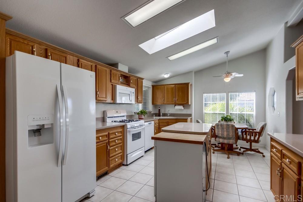 9500 Harritt Road, Unit 106 Lakeside, CA 92040 - Photo 3 of 35 a kitchen with a refrigerator and a stove top oven