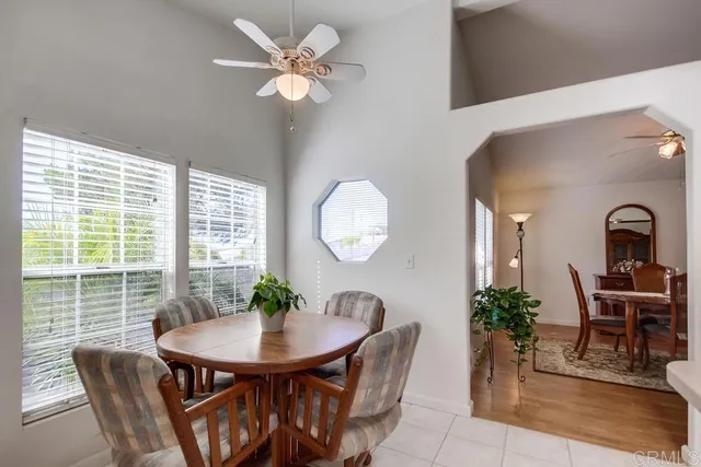 a view of a dining room with furniture and a potted plant