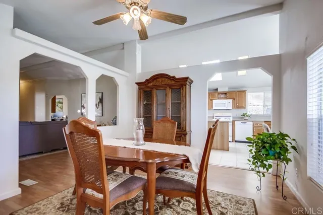 a view of a dining room with furniture and a chandelier