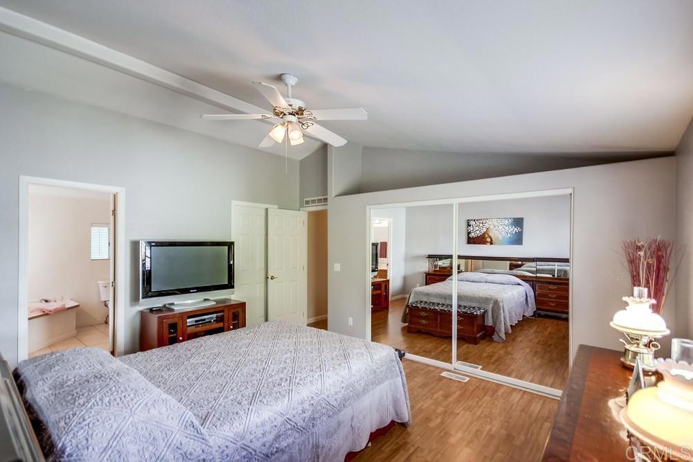 9500 Harritt Road, Unit 106 Lakeside, CA 92040 - Photo 8 of 35 a bedroom with a bed and a flat screen tv