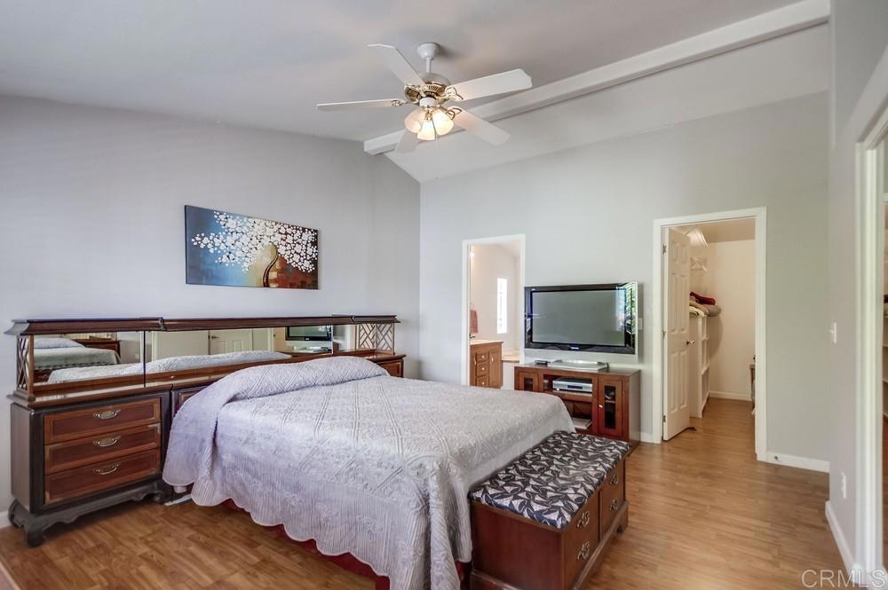 9500 Harritt Road, Unit 106 Lakeside, CA 92040 - Photo 9 of 35 a bedroom with a bed a dresser and wooden floor