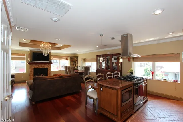 a kitchen with stainless steel appliances granite countertop a stove and a wooden floors