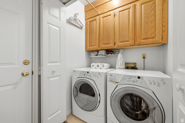 3766 Cardiff Circle Bountiful, UT 84010 - Photo 21 of 46 Laundry area featuring wood-finish cabinetry, a built-in hanging rod, and light-toned flooring