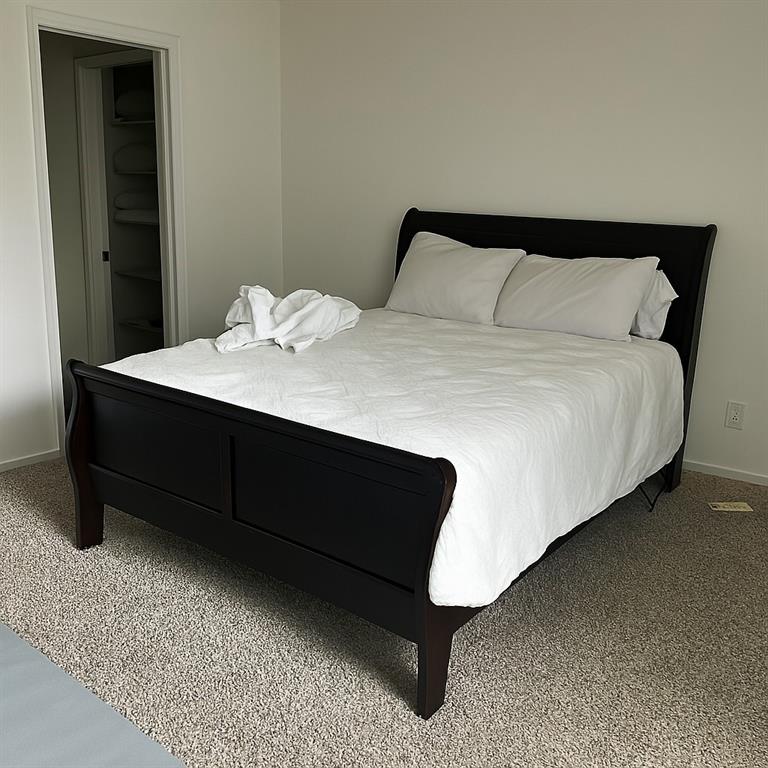 9254 Forest Lane, Unit 304 Dallas, TX 75243 - Photo 12 of 17 a bedroom with a bed and a night stand