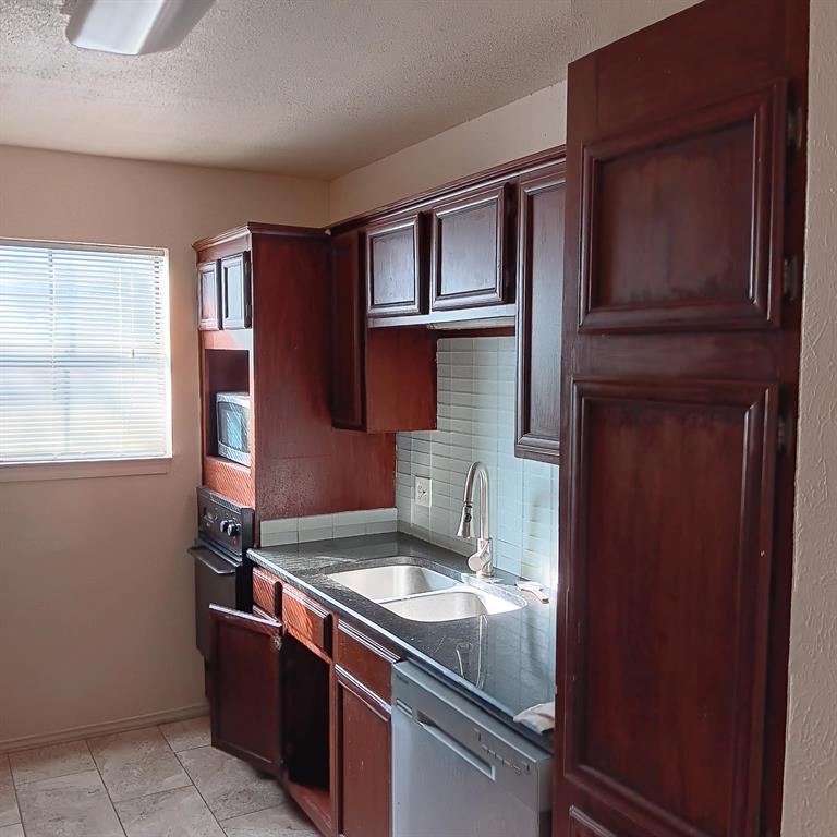 9254 Forest Lane, Unit 304 Dallas, TX 75243 - Photo 8 of 17 a room with stainless steel appliances granite countertop a refrigerator and a sink