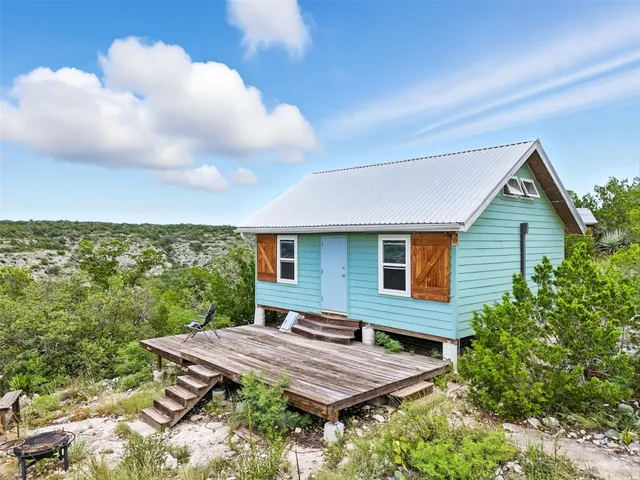 a view of a backyard with plants and a garden