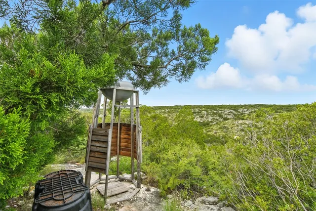 a view of a balcony with chair and potted plants
