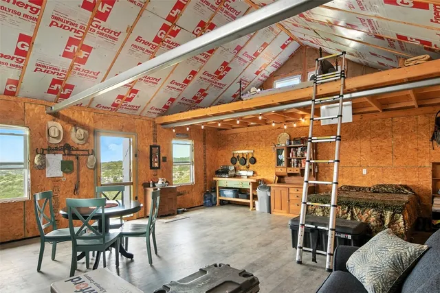 a dining room with furniture water view and a flat screen tv