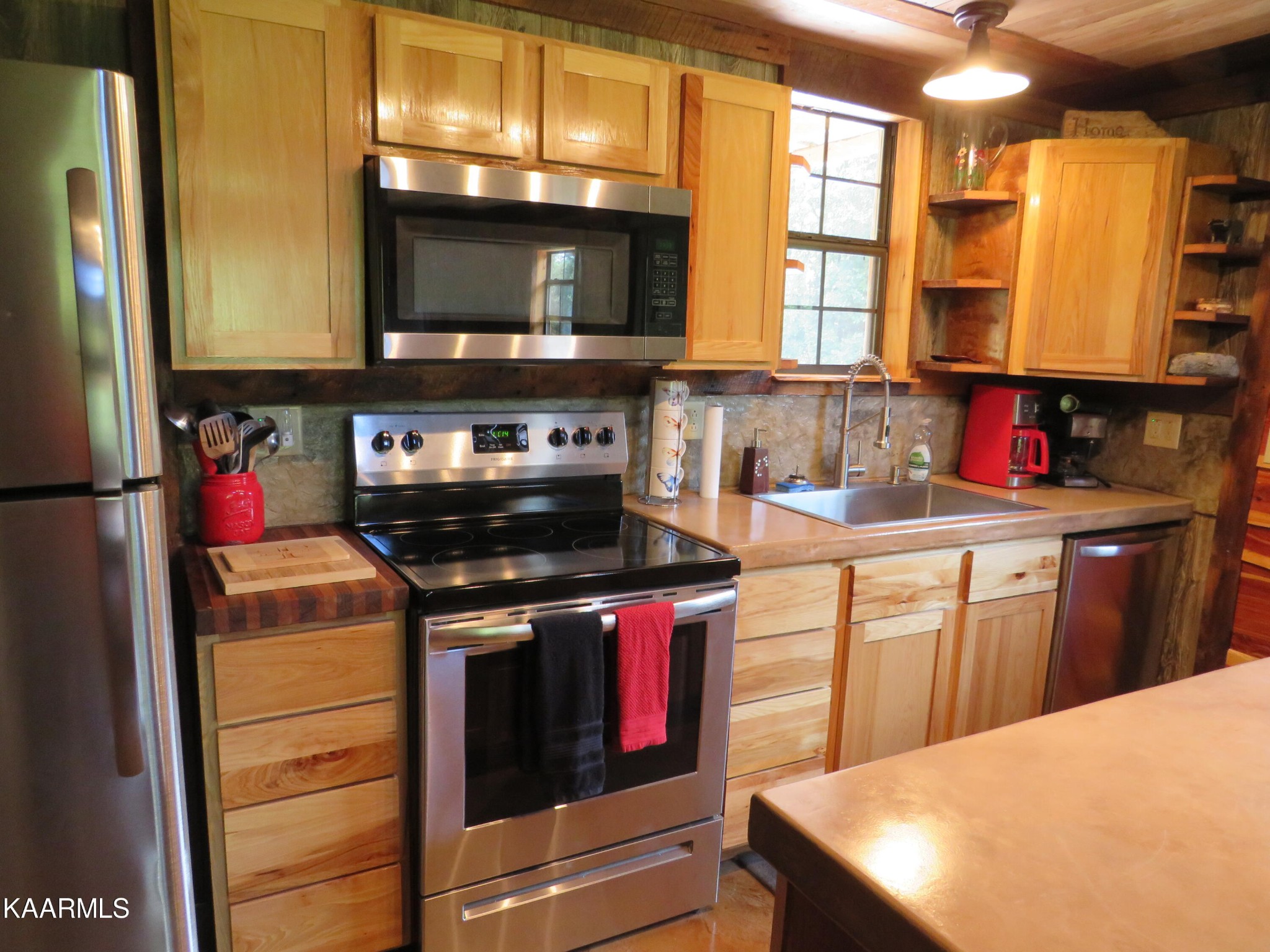 266 Ross Williams Road Lancing, TN 37770 - Photo 11 of 39 a kitchen with stainless steel appliances granite countertop a stove a sink and a microwave