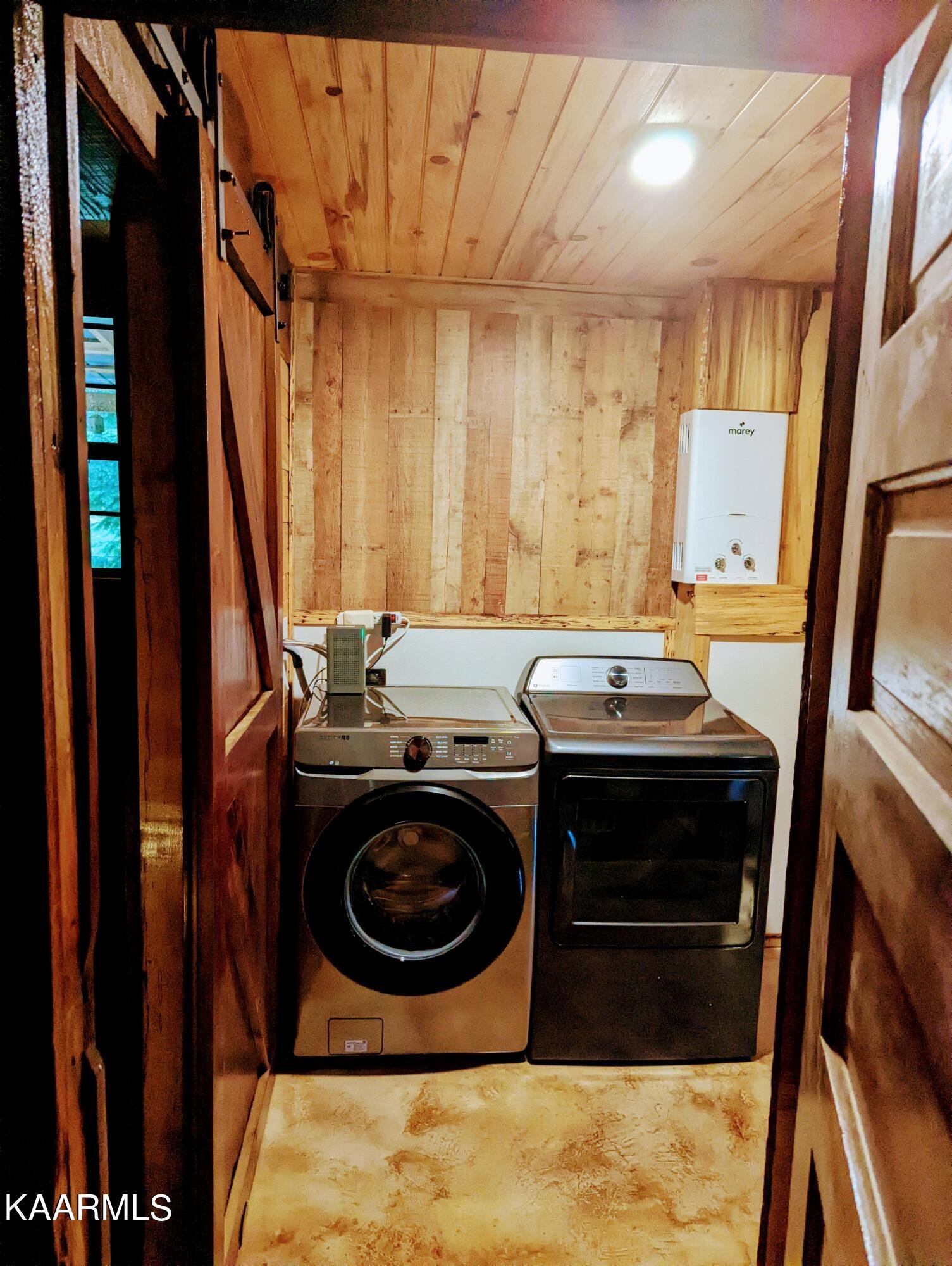 266 Ross Williams Road Lancing, TN 37770 - Photo 13 of 39 a bathroom with a sink a washer and dryer
