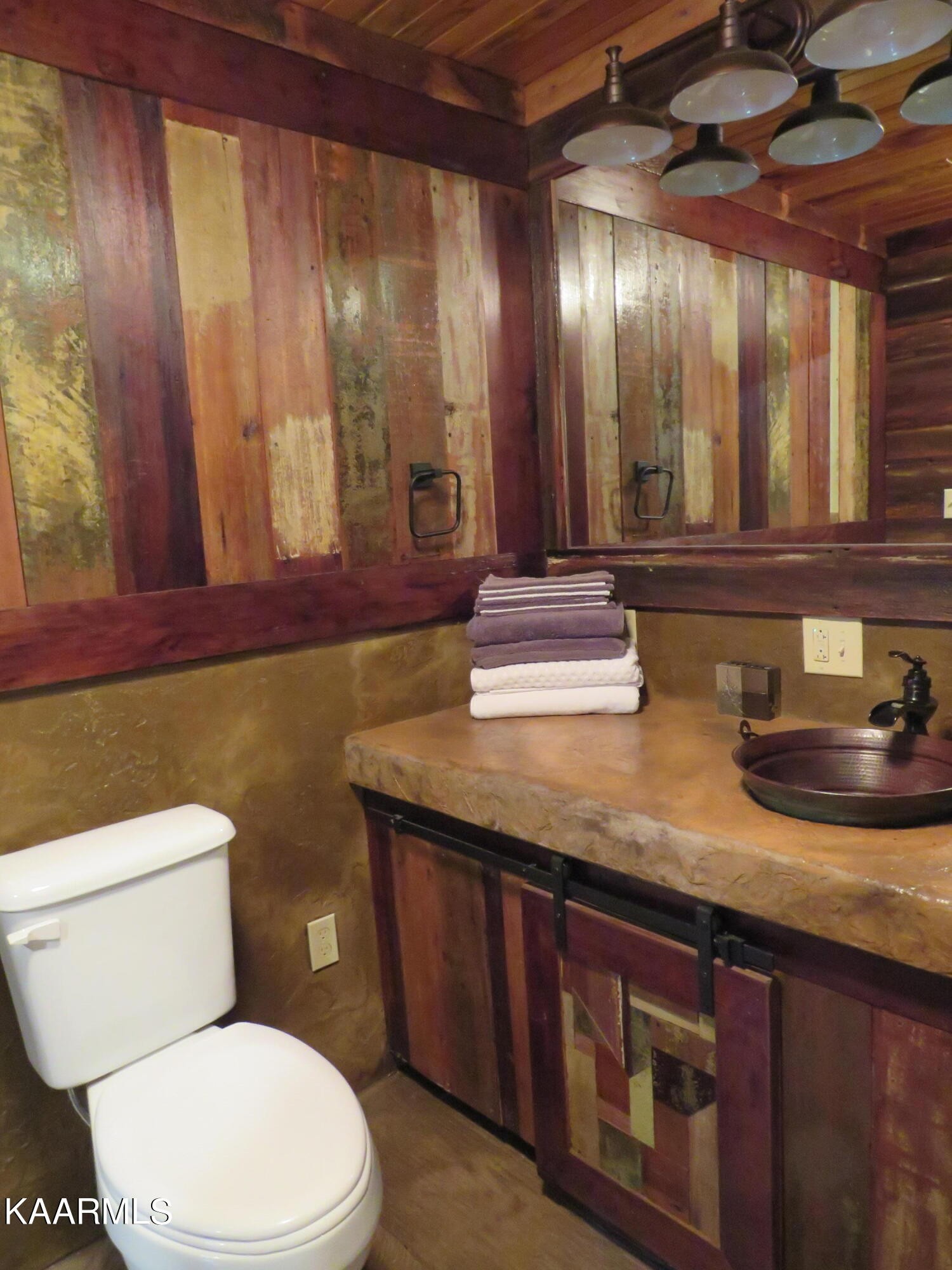 266 Ross Williams Road Lancing, TN 37770 - Photo 15 of 39 a bathroom with a granite countertop sink a toilet and mirror