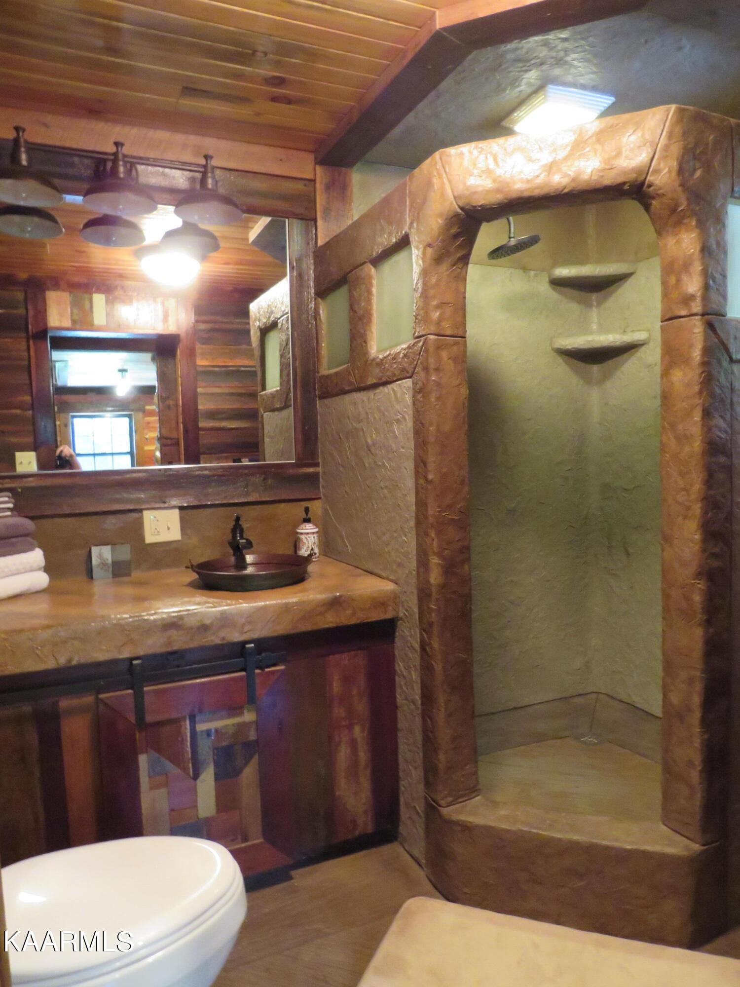 266 Ross Williams Road Lancing, TN 37770 - Photo 16 of 39 a bathroom with a sink a toilet and shower