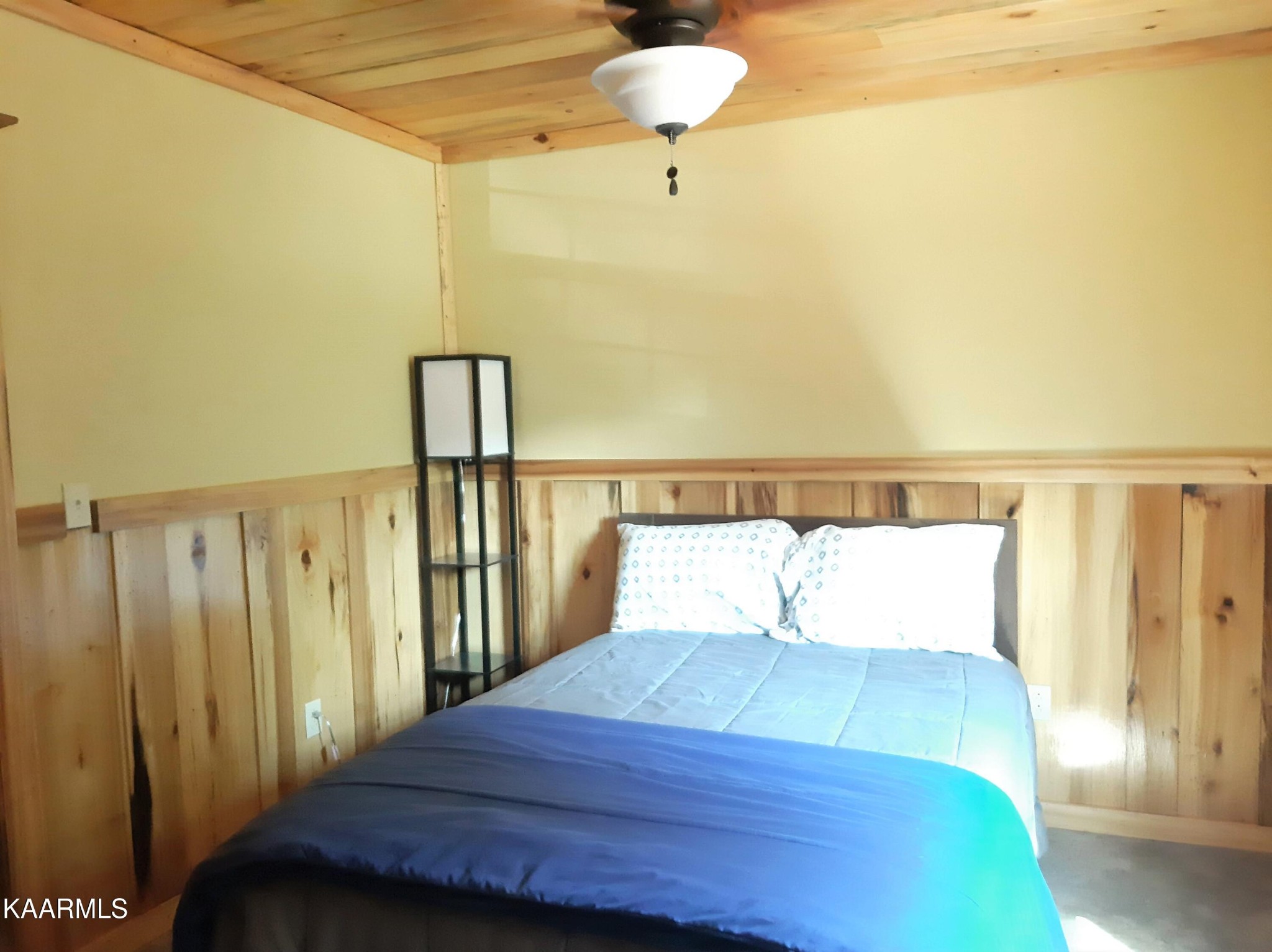 266 Ross Williams Road Lancing, TN 37770 - Photo 24 of 39 a bedroom with a bed and painting on the wall