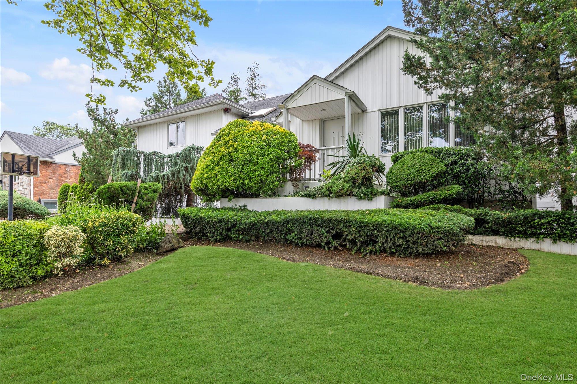 a front view of a house with a garden