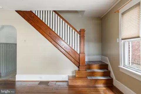 a view of entryway and hall with wooden floor