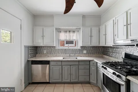 a kitchen with cabinets appliances and a sink
