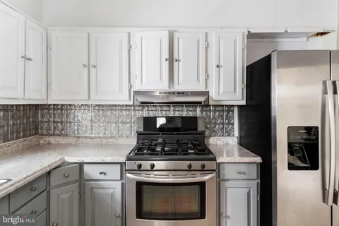 a kitchen with cabinets appliances and a sink