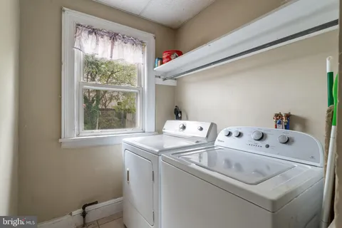 a kitchen with a sink a counter top space and cabinets