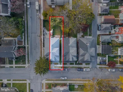 an aerial view of multi story residential apartment building with yard