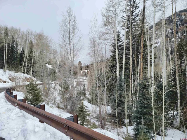 a dining room with furniture a fireplace and large windows