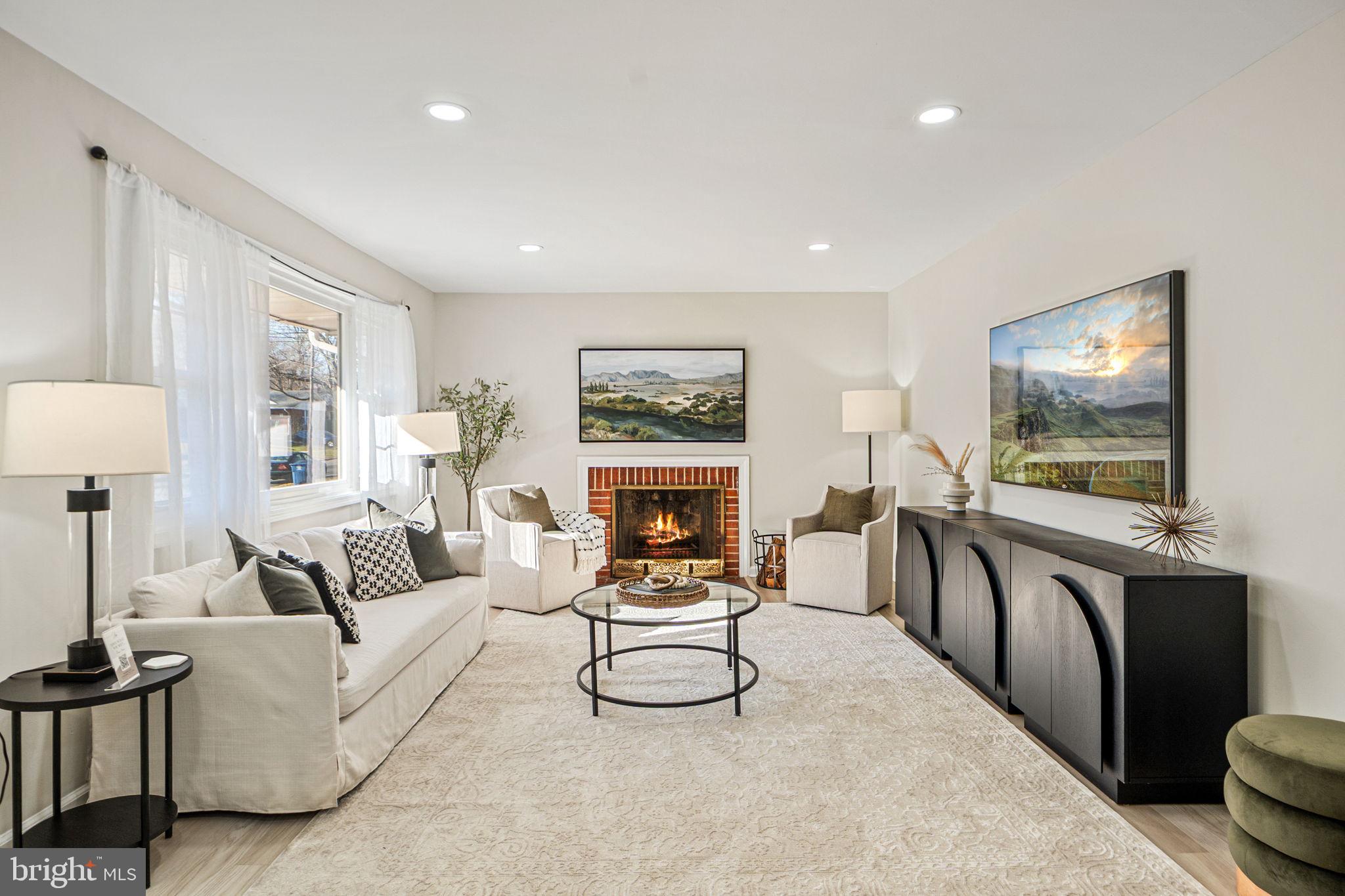 1513 Flora Lane Silver Spring, MD 20910 - Photo 4 of 49 a living room with furniture a fireplace and a flat screen tv