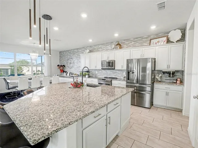 a bed room with a bed and paintings on the wall