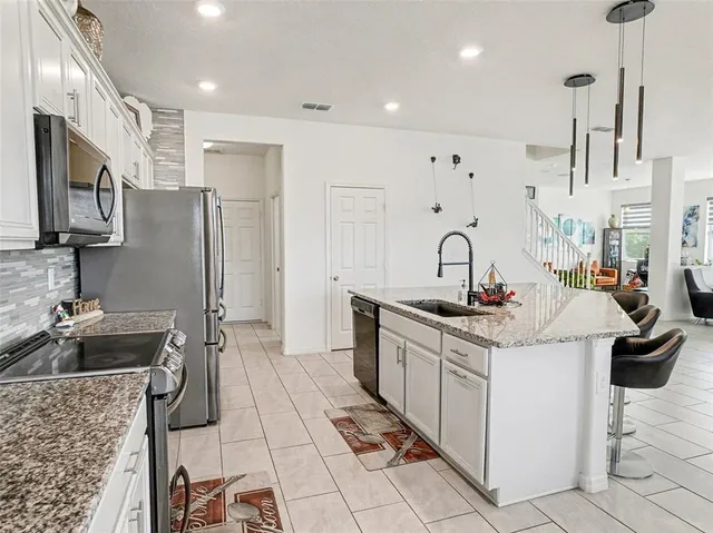a large bed sitting in a bedroom next to a window