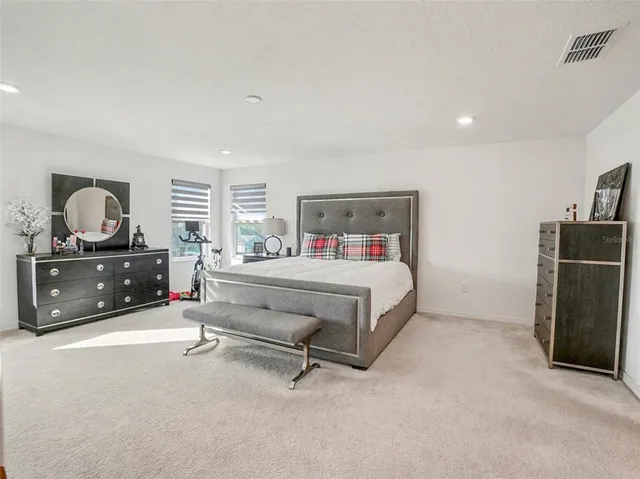 a bathroom with a granite countertop sink a toilet and a mirror