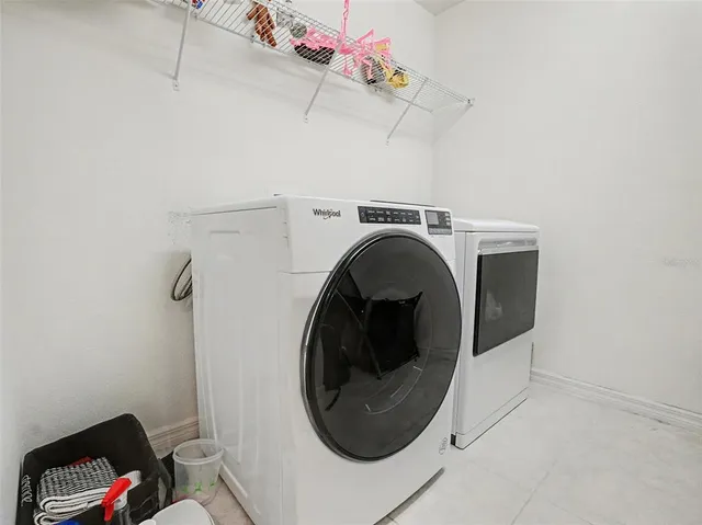 a view of a living room with furniture and a potted plant