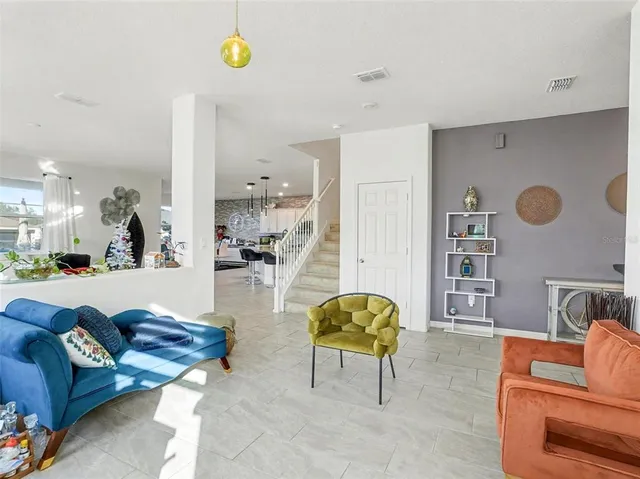 a living room with furniture and kitchen view