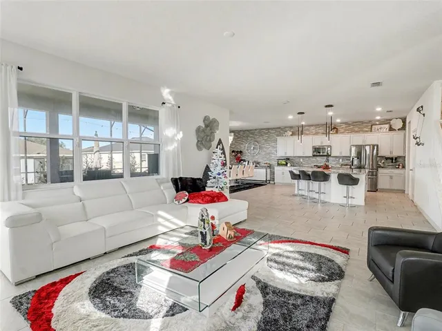 a living room with lots of furniture and clutter