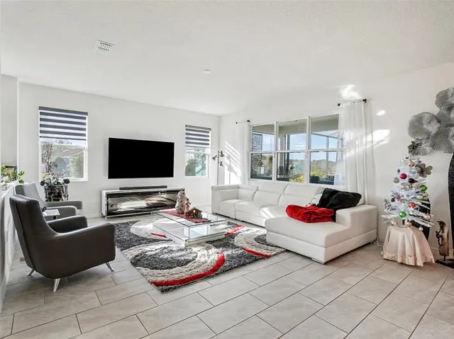 a kitchen with stainless steel appliances kitchen island granite countertop a stove a sink and a refrigerator