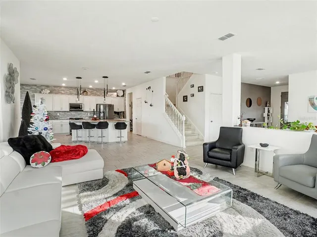a kitchen with stainless steel appliances granite countertop a sink refrigerator and cabinets