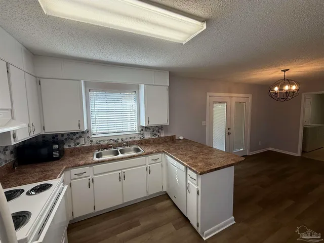 a kitchen that has a sink and a stove in it