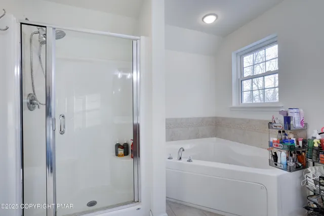 a bathroom with a granite countertop sink and a shower