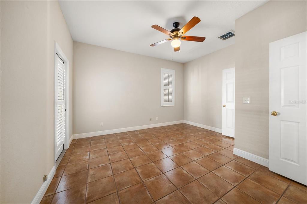 270 2nd Avenue Southwest Largo, FL 33770 - Photo 48 of 67 an empty room with windows and ceiling fan