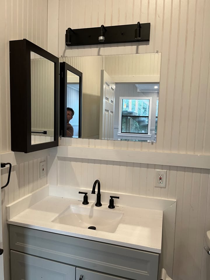 3505 Lone Man Mountain Road, Unit A Wimberley, TX 78676 - Photo 9 of 11 A well-appointed bathroom features a contemporary vanity with a sleek sink, offering a crisp, clean aesthetic.