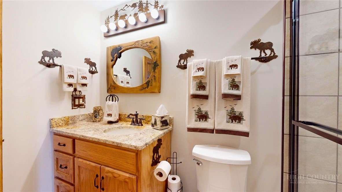250 Ridgeview Road, Unit 43 Sugar Mountain, NC 28604 - Photo 19 of 21 a bathroom with a sink mirror vanity and toilet
