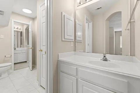 a bathroom with a sink vanity and a mirror