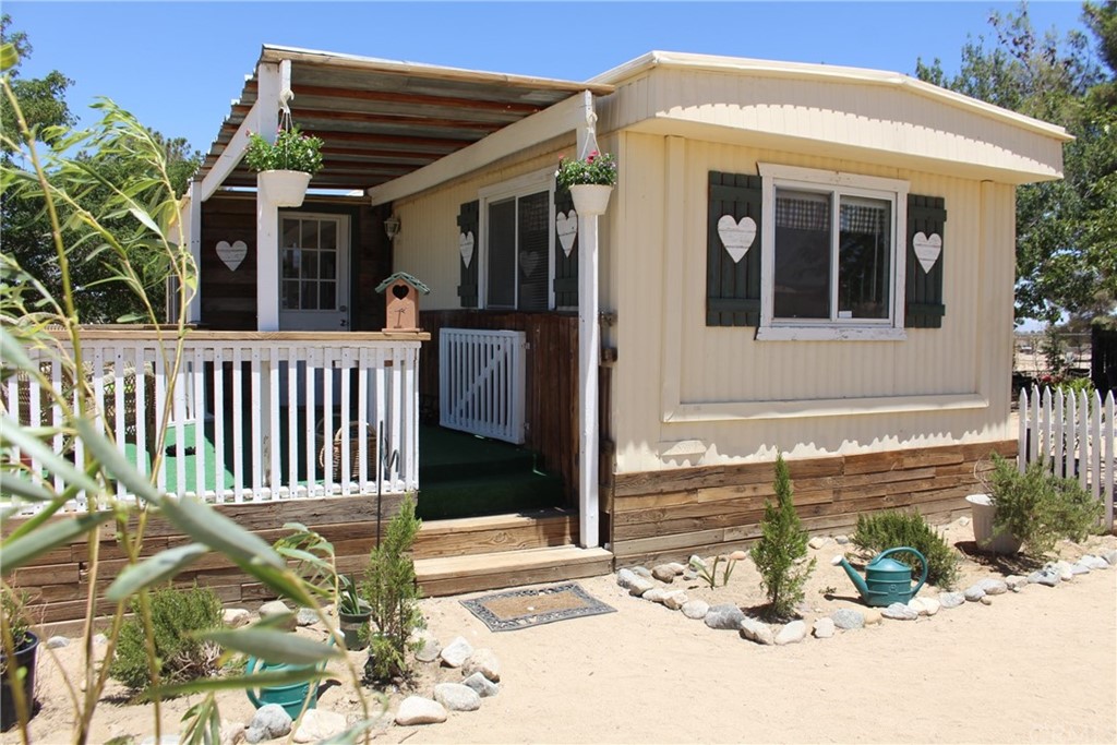11414 Eaby Road Phelan, CA 92371 - Photo 1 of 1 a view of a house with a wooden fence