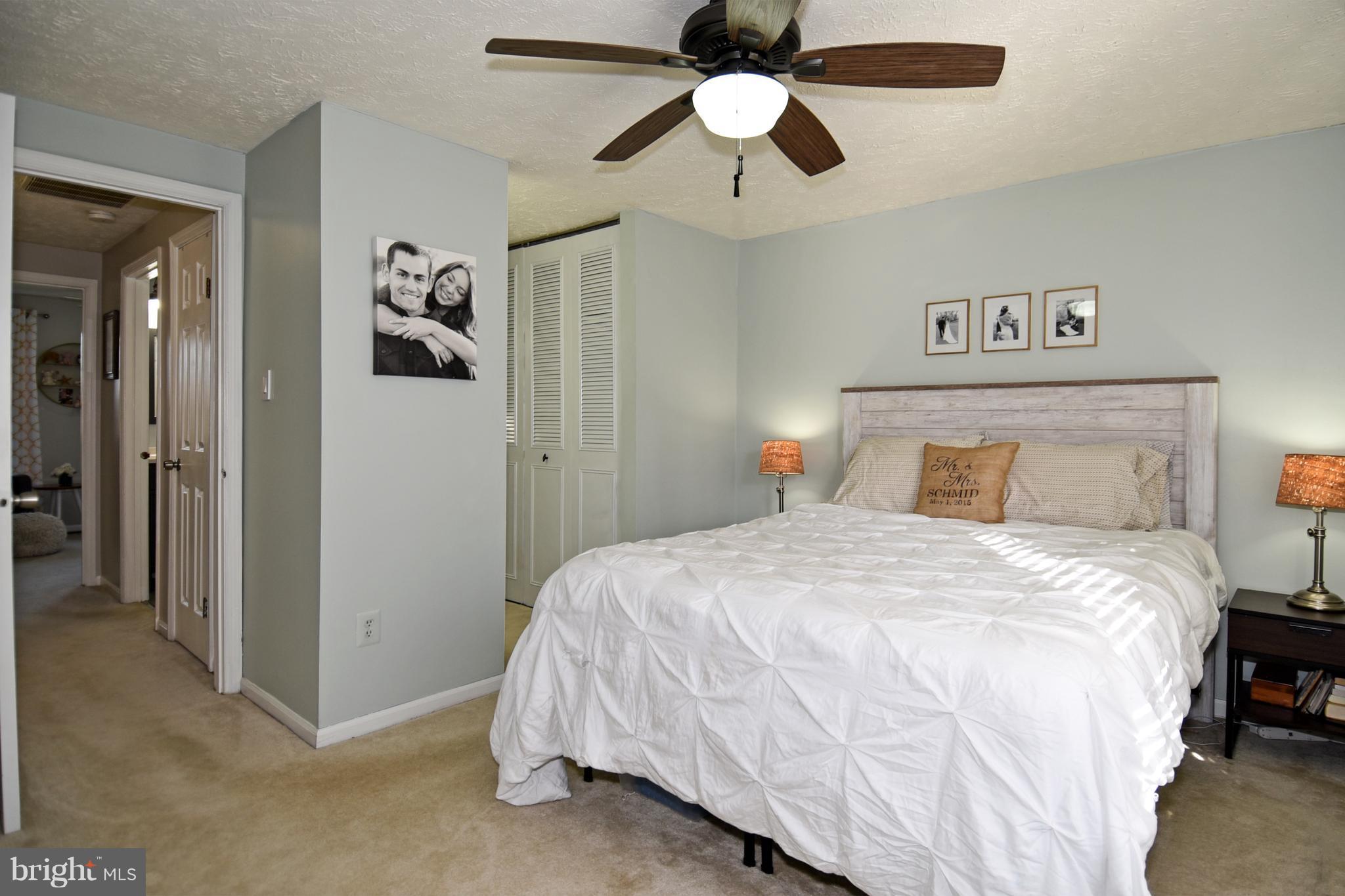 1615 Fieldthorn Drive Reston, VA 20194 - Photo 14 of 28 a bedroom with a bed and a chandelier