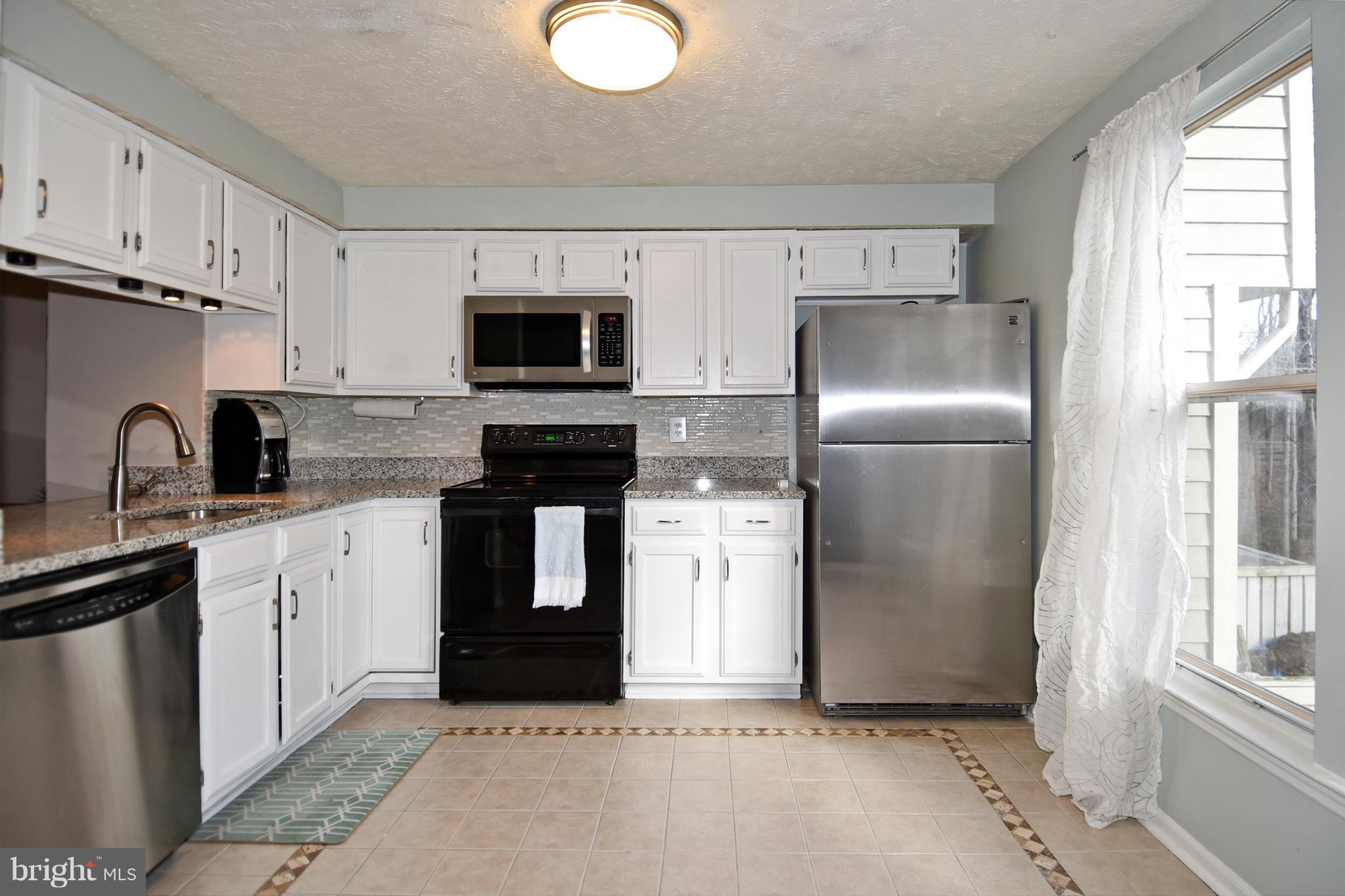 1615 Fieldthorn Drive Reston, VA 20194 - Photo 7 of 28 a kitchen with stainless steel appliances granite countertop a refrigerator sink and stove